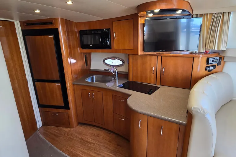 Slide: The Image of Interior of 2006 Carver 36 Mariner yacht with kitchen and entertainment area. - 30