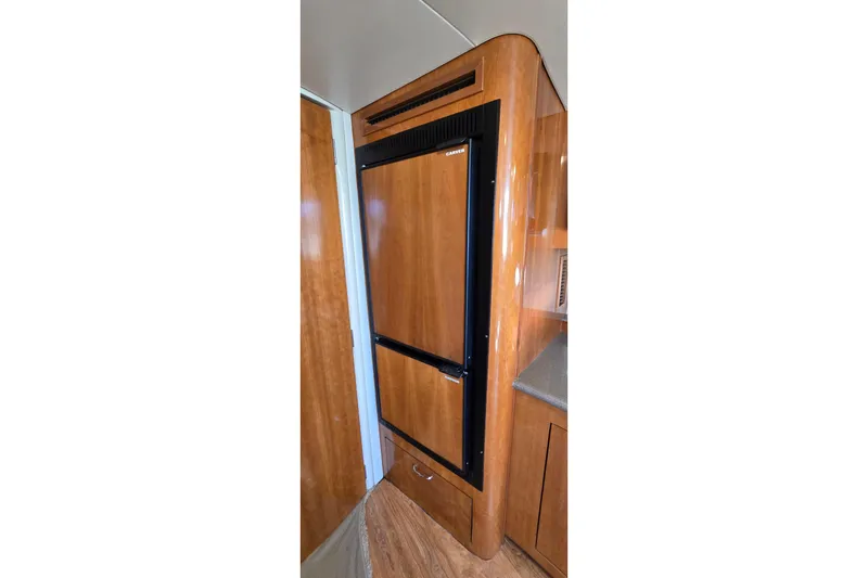 Slide: The Image of Wood-paneled refrigerator in 2006 Carver 36 Mariner yacht interior. - 31