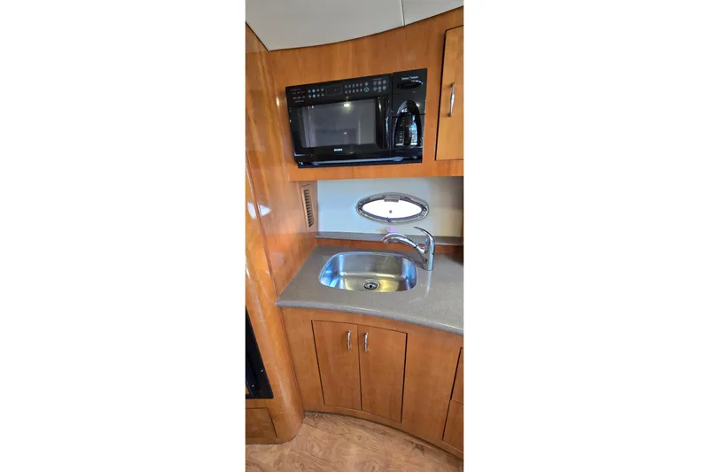 Slide: The Image of 2006 Carver 36 Mariner kitchen with microwave, sink, and wooden cabinetry. - 32