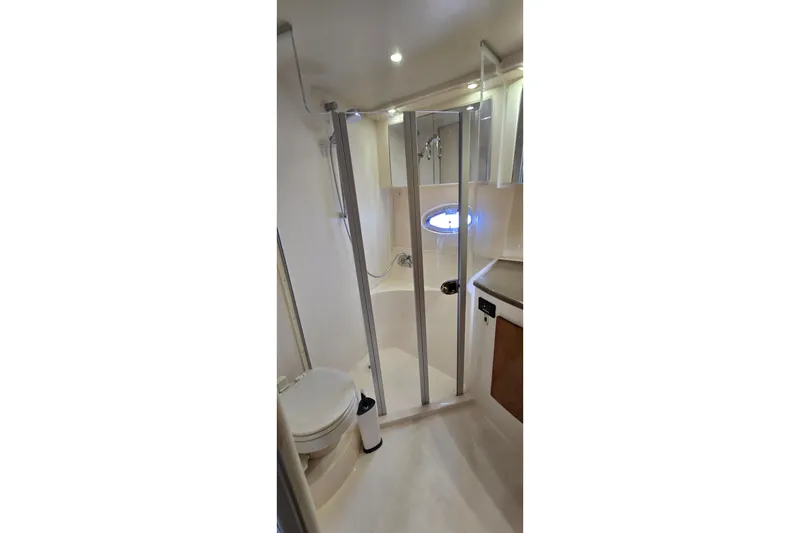 Slide: The Image of Bathroom interior of 2006 Carver 36 Mariner yacht, featuring shower and toilet. - 35