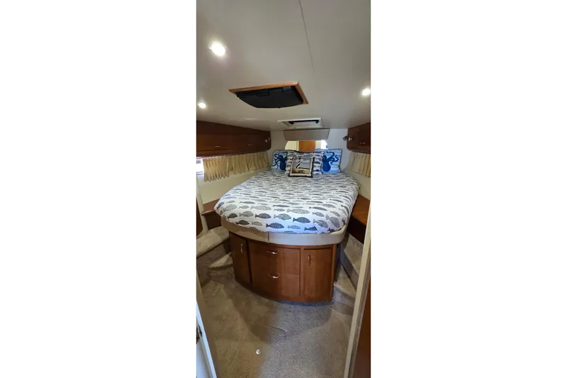 Slide: The Image of Interior cabin of 2006 Carver 36 Mariner with cozy bed and wooden cabinetry. - 36