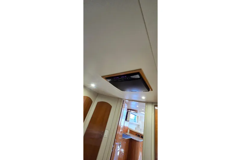 Slide: The Image of Interior view of 2006 Carver 36 Mariner yacht, featuring ceiling lights and wooden cabinetry. - 39