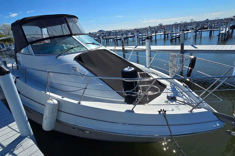 Slide: The Image of 2006 Carver 36 Mariner docked at marina under clear blue sky. - 5