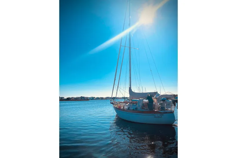 Slide: The Image of Sailboat on calm water under bright sun, Baba 30 model, 1979. - 2