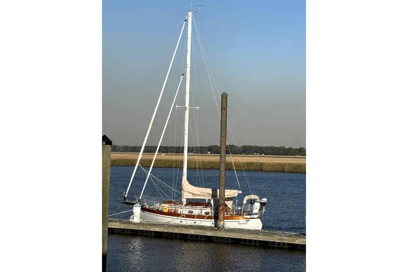Slide: The Image of Sailboat docked on calm water, Baba 30 model, 1979, under clear blue sky. - 4