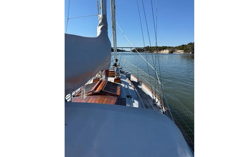 Slide: The Image of Sailing on a 1979 Baba 30 yacht in calm waters under a clear blue sky. - 7