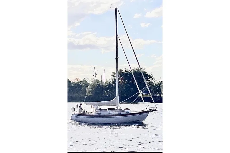 Slide: The Image of Sailboat on water, Baba 30 model, 1979, with trees in the background. - 8