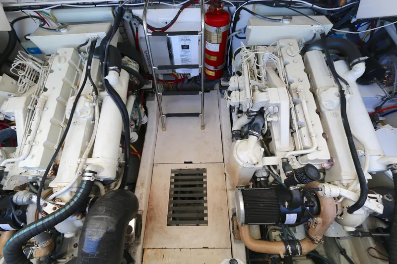 Slide: The Image of Engine room of a 2005 Tiara Yachts 3800 Open, featuring dual engines and equipment. - 12