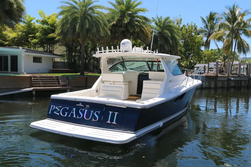 Slide: The Image of 2005 Tiara Yachts 3800 Open, docked near palm trees, named "PEGASUS II". - 16