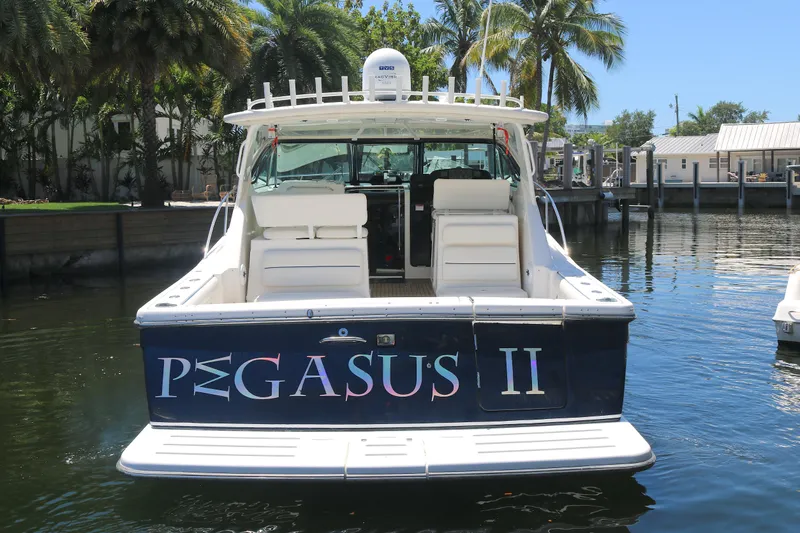 Slide: The Image of 2005 Tiara Yachts 3800 Open, named "Pegasus II," docked in a sunny marina. - 17