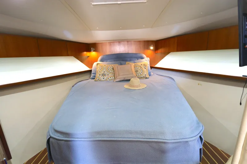 Slide: The Image of Luxurious cabin interior of 2005 Tiara Yachts 3800 Open with cozy bedding. - 3