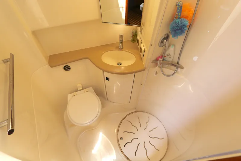 Slide: The Image of Bathroom interior of 2005 Tiara Yachts 3800 Open, featuring sink, toilet, and shower. - 5
