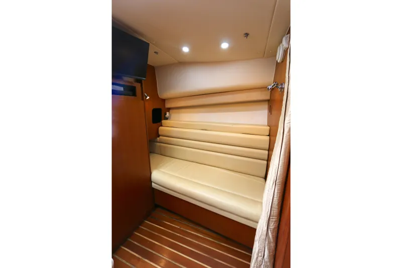 Slide: The Image of Interior cabin of 2005 Tiara Yachts 3800 Open with beige seating and wood flooring. - 6