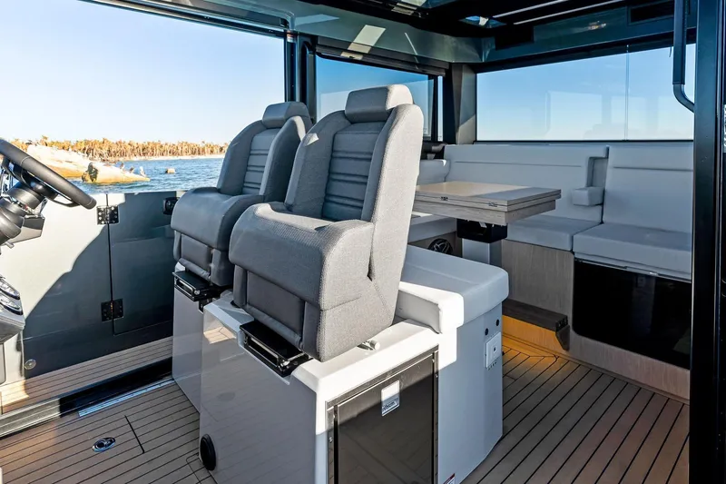 Slide: The Image of Interior of 2026 XO EXPLR 44 yacht with modern seating and sleek design. - 13