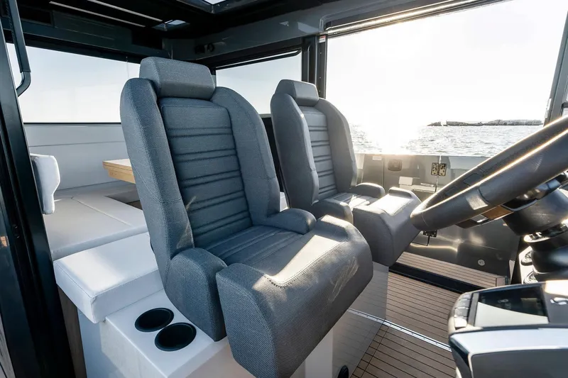 Slide: The Image of Interior of 2026 XO EXPLR 44 boat with modern seating and steering wheel. - 15