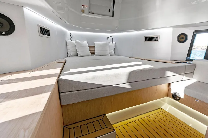 Slide: The Image of Luxurious interior cabin of 2026 XO EXPLR 44 yacht with modern bedding and ambient lighting. - 19