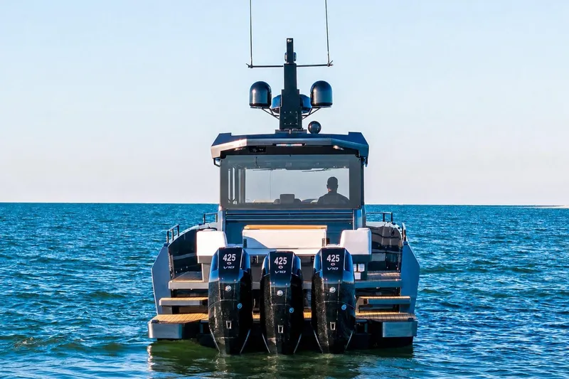 Slide: The Image of 2026 XO EXPLR 44 boat with triple 425 engines on open water. - 5