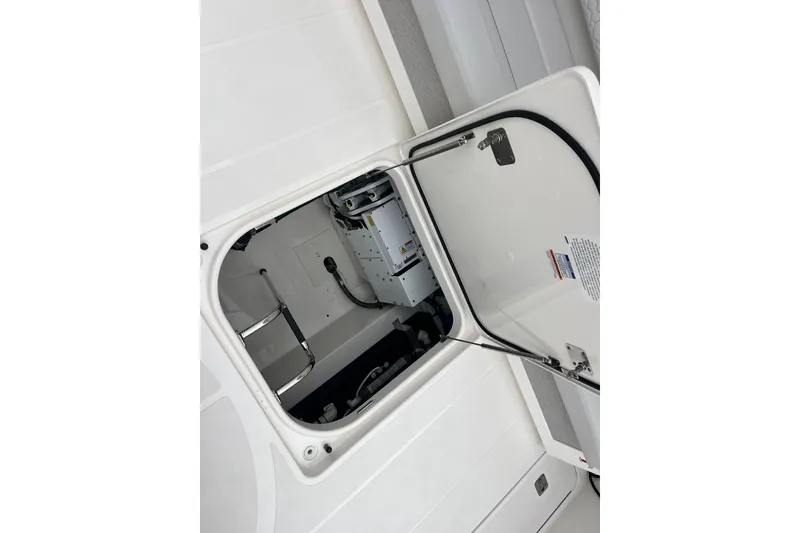 Slide: The Image of Open hatch of 2023 Tiara Yachts 43 LS, revealing interior equipment and ladder. - 11