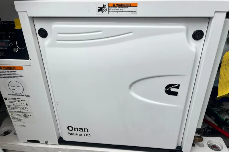 Slide: The Image of Onan Marine QD generator in 2023 Tiara Yachts 43 LS, featuring Cummins branding. - 13