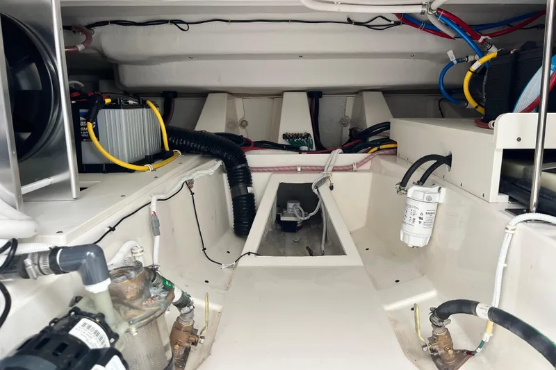 Slide: The Image of Engine compartment of 2023 Tiara Yachts 43 LS, showcasing wiring and mechanical components. - 14