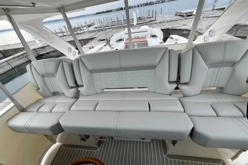 Slide: The Image of Luxurious seating on 2023 Tiara Yachts 43 LS, docked by the water. - 18