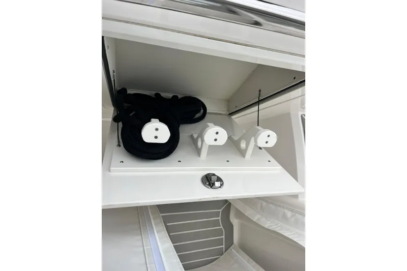 Slide: The Image of Storage compartment on 2023 Tiara Yachts 43 LS, featuring ropes and accessories. - 22
