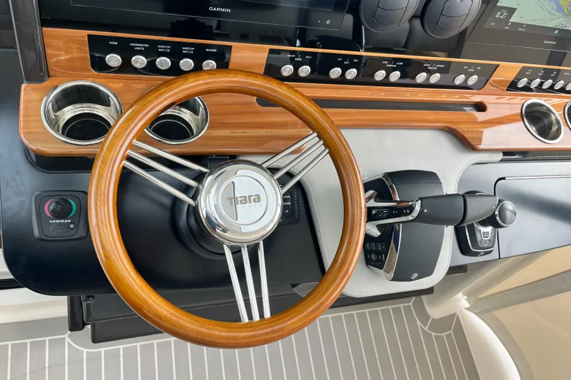 Slide: The Image of 2023 Tiara Yachts 43 LS helm with wooden steering wheel and modern controls. - 24