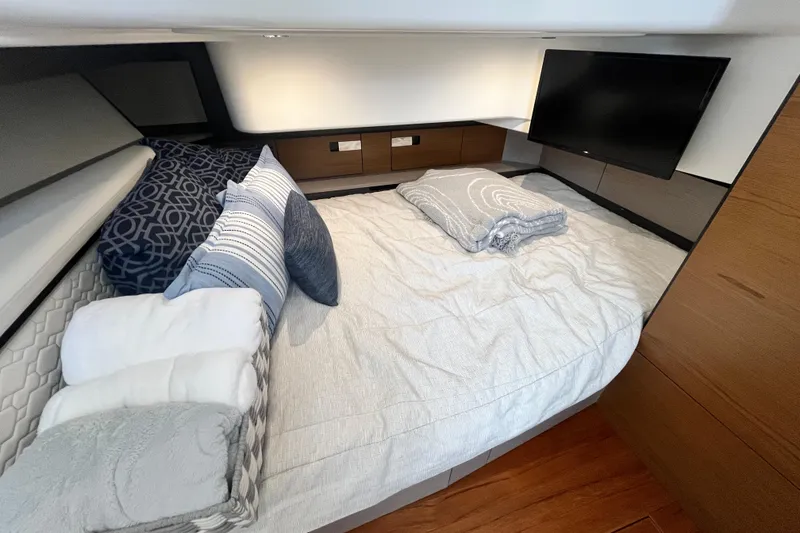 Slide: The Image of Luxurious cabin interior of 2023 Tiara Yachts 43 LS with cozy bedding and TV. - 29