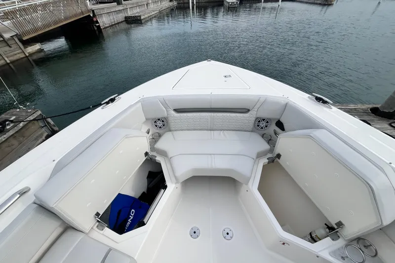 Slide: The Image of 2023 Tiara Yachts 43 LS boat interior with white seating and storage compartments. - 38