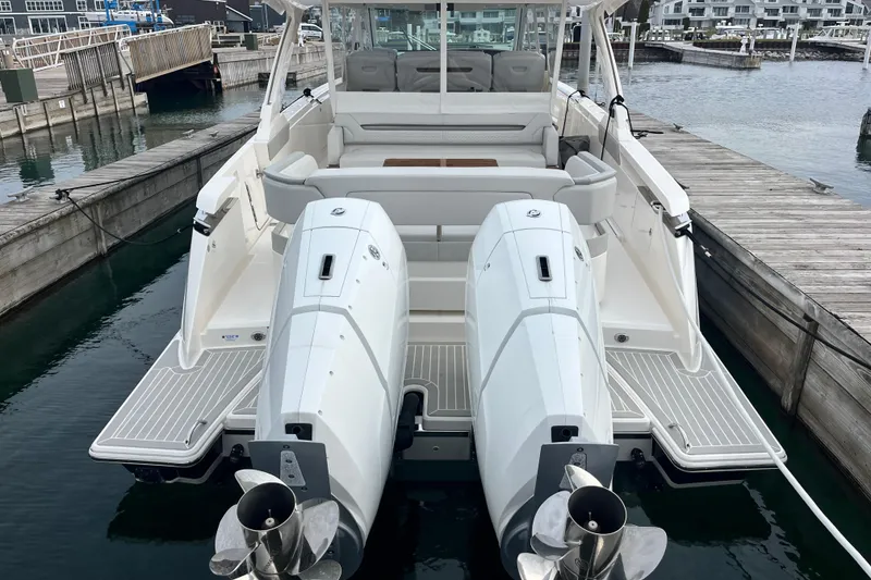 Slide: The Image of 2023 Tiara Yachts 43 LS with dual outboard engines docked at marina. - 4