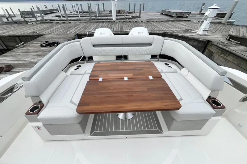 Slide: The Image of Luxurious seating area on 2023 Tiara Yachts 43 LS with wooden table and white cushions. - 5