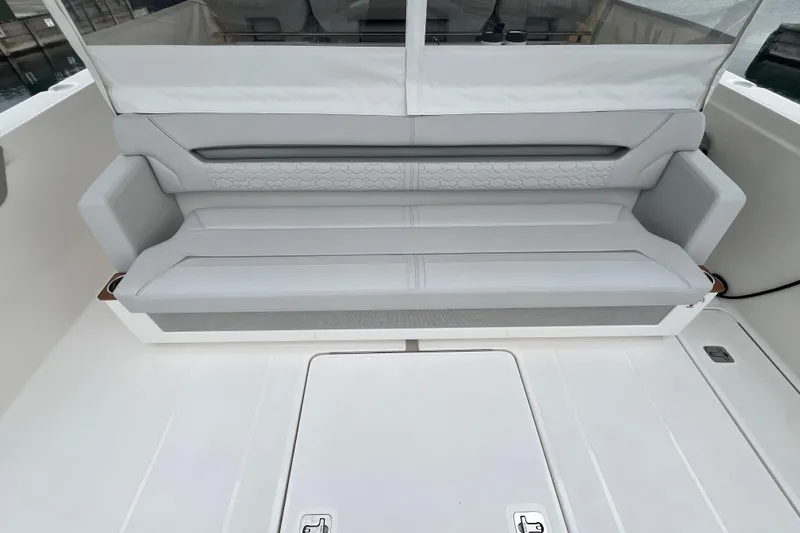 Slide: The Image of 2023 Tiara Yachts 43 LS boat interior with sleek, modern seating design. - 8