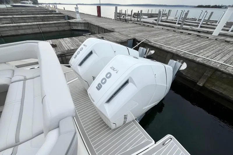 Slide: The Image of 2023 Tiara Yachts 43 LS with twin outboard engines docked at a marina. - 9
