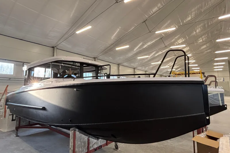 The Image of 2026 XO EXPLR 9 boat in a well-lit indoor facility. - 1
