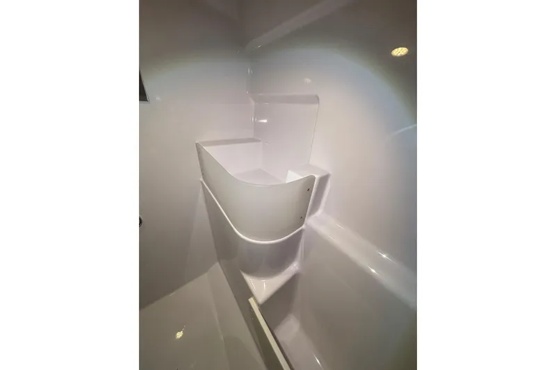 Slide: The Image of Interior of 2026 XO EXPLR 9 boat, featuring sleek white storage compartment. - 10