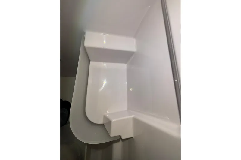 Slide: The Image of Interior view of 2026 XO EXPLR 9 boat's sleek, modern white compartment. - 15
