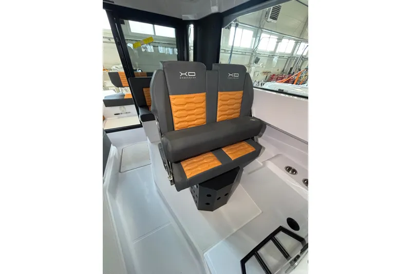 Slide: The Image of 2026 XO EXPLR 9 boat interior with stylish orange and gray seating. - 16