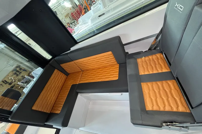 Slide: The Image of Interior seating of 2026 XO EXPLR 9 boat with orange and gray upholstery. - 17