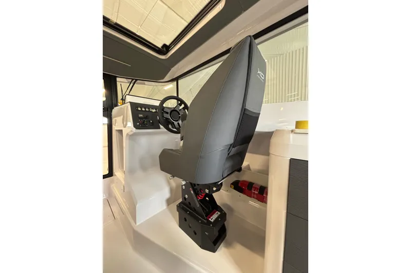 Slide: The Image of Interior of 2026 XO EXPLR 9 boat showing helm seat and steering console. - 24