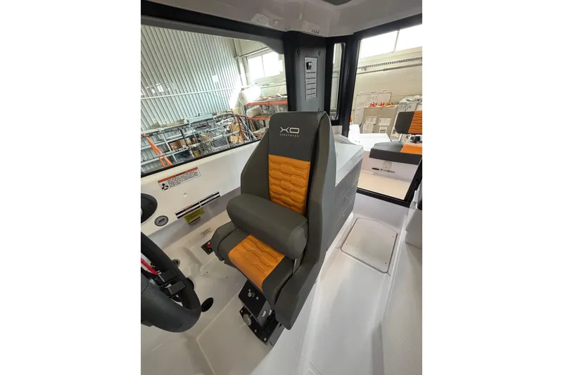 Slide: The Image of 2026 XO EXPLR 9 boat interior with orange and gray seating in a modern cabin. - 25