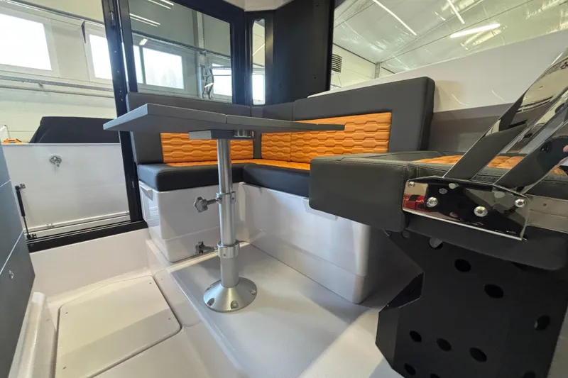 Slide: The Image of Modern interior of 2026 XO EXPLR 9 boat with sleek seating and table design. - 30