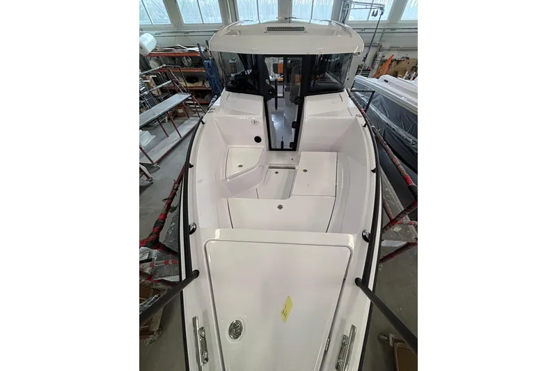 Slide: The Image of 2026 XO EXPLR 9 boat interior in a workshop setting. - 4