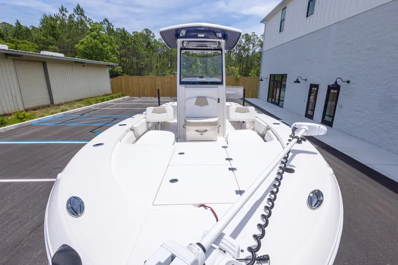Slide: The Image of 2024 Robalo 246 Cayman boat parked outdoors near buildings. - 10