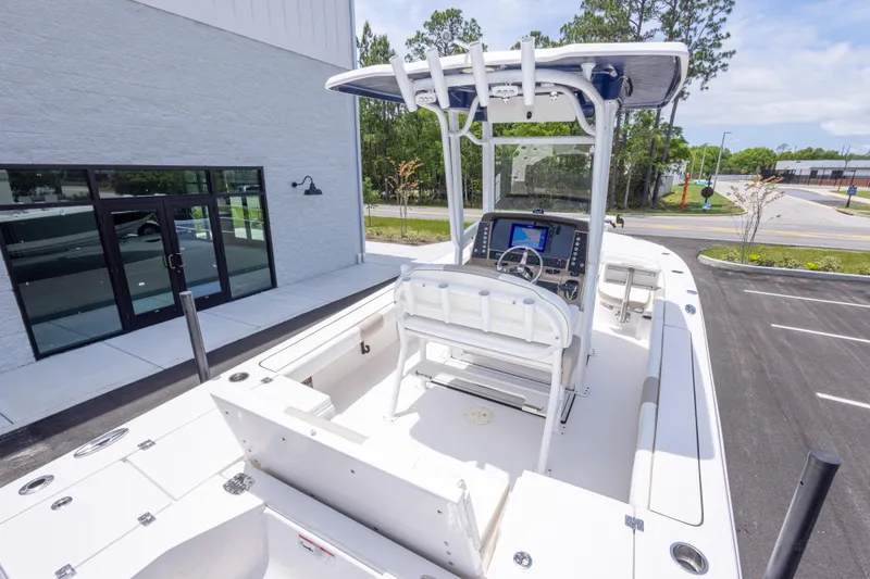 Slide: The Image of 2024 Robalo 246 Cayman boat with center console and T-top in a parking lot. - 11