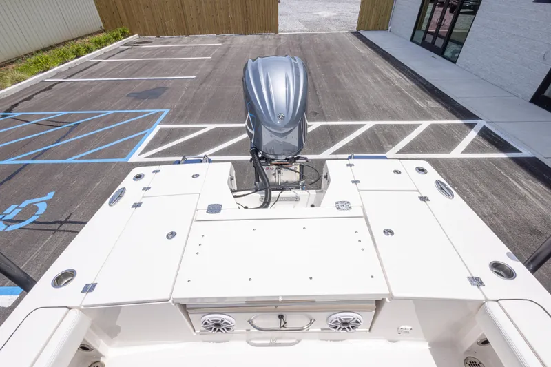 Slide: The Image of 2024 Robalo 246 Cayman boat with outboard motor in a parking lot. - 19
