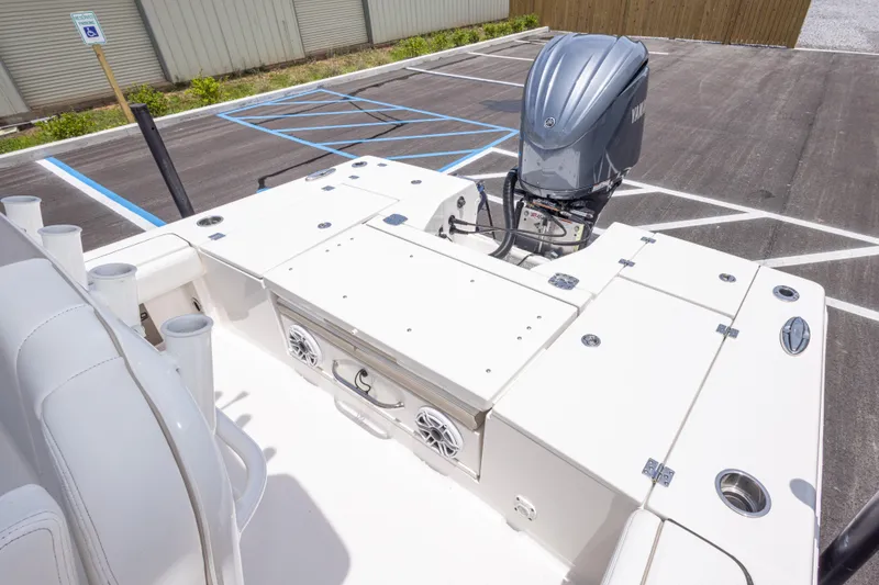 Slide: The Image of 2024 Robalo 246 Cayman boat deck with Yamaha outboard motor in parking lot. - 20