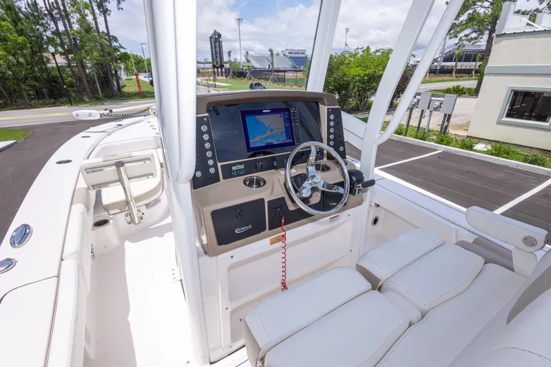 Slide: The Image of 2024 Robalo 246 Cayman boat cockpit with modern navigation system and comfortable seating. - 21