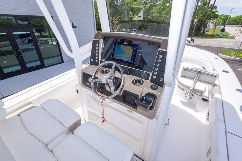 Slide: The Image of 2024 Robalo 246 Cayman boat cockpit with modern navigation system and steering wheel. - 22