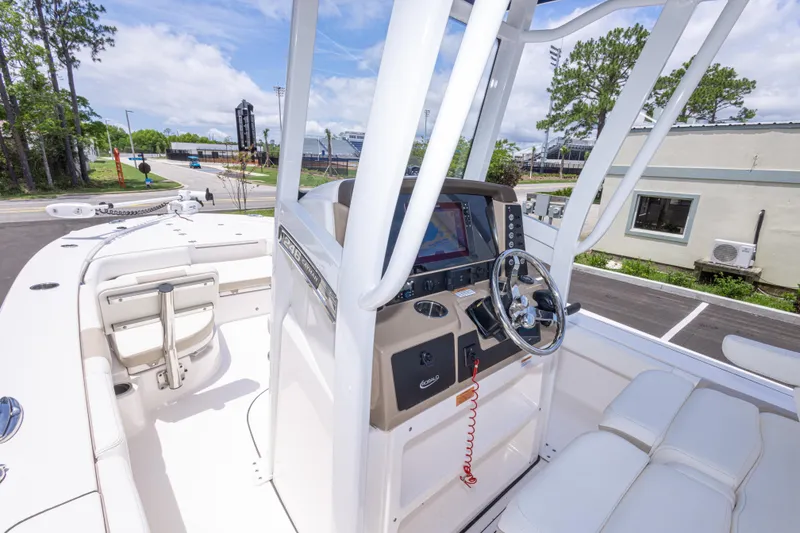 Slide: The Image of 2024 Robalo 246 Cayman boat interior with steering console and seating. - 26