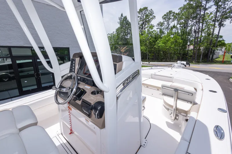Slide: The Image of 2024 Robalo 246 Cayman boat interior with steering console and seating, showcasing modern design. - 27